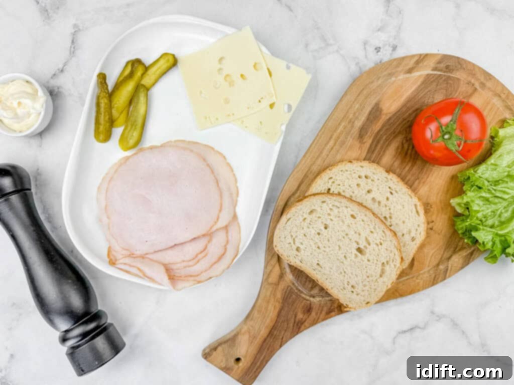 Ingredients of What She's Having Sandwich laying on top of white marble countertop.