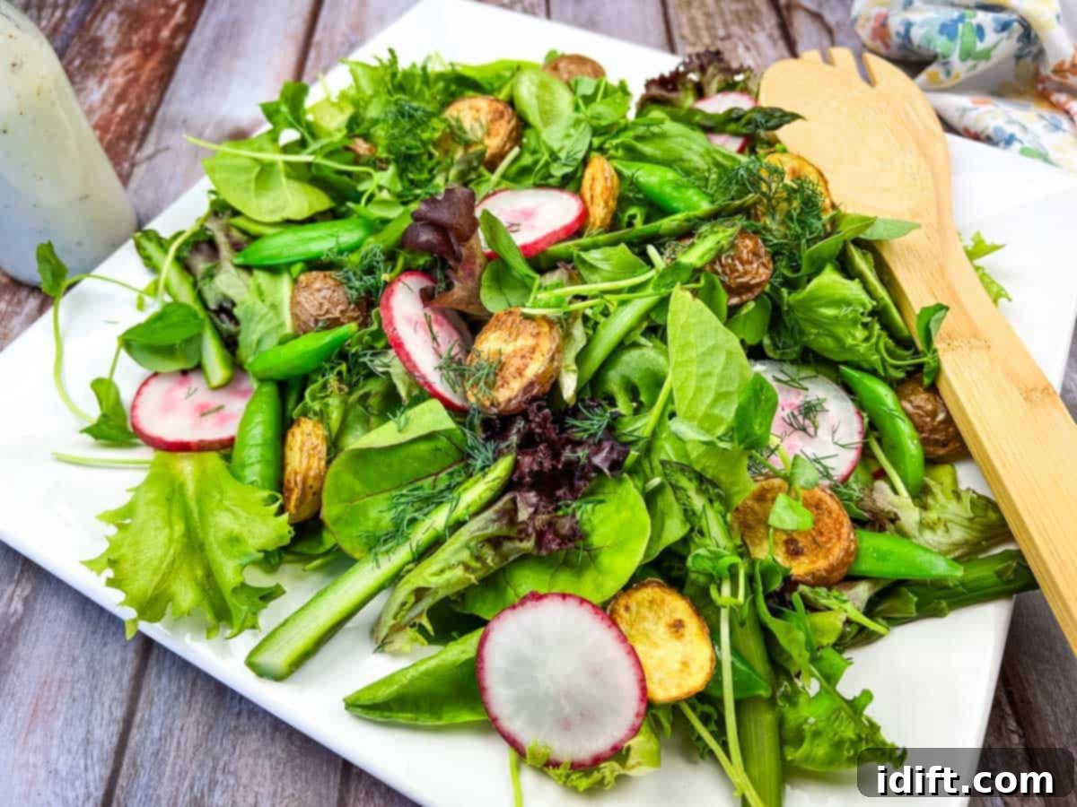 17 Effortless Sides That Prove Dinner Doesn't Have To Be Hard 11 Spring salad with asparagus and potatoes on a white plate.
