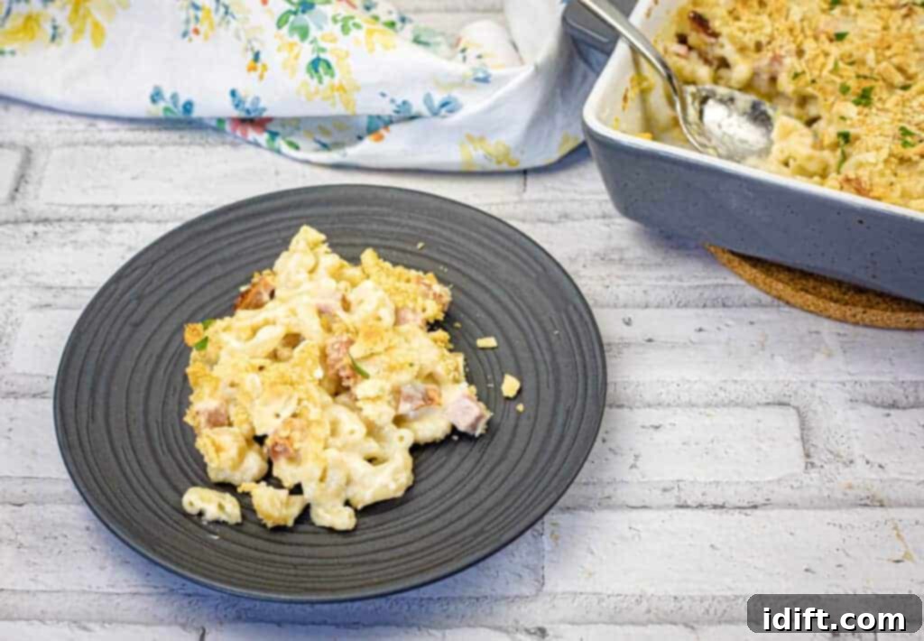 17 Effortless Sides That Prove Dinner Doesn't Have To Be Hard 12 A portion of Old Fashioned Mac & Cheese on a black plate.