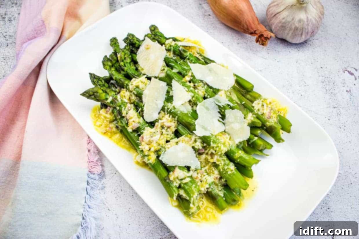 17 Effortless Sides That Prove Dinner Doesn't Have To Be Hard 16 Asparagus with Lemon and Parmesan on a white platter.