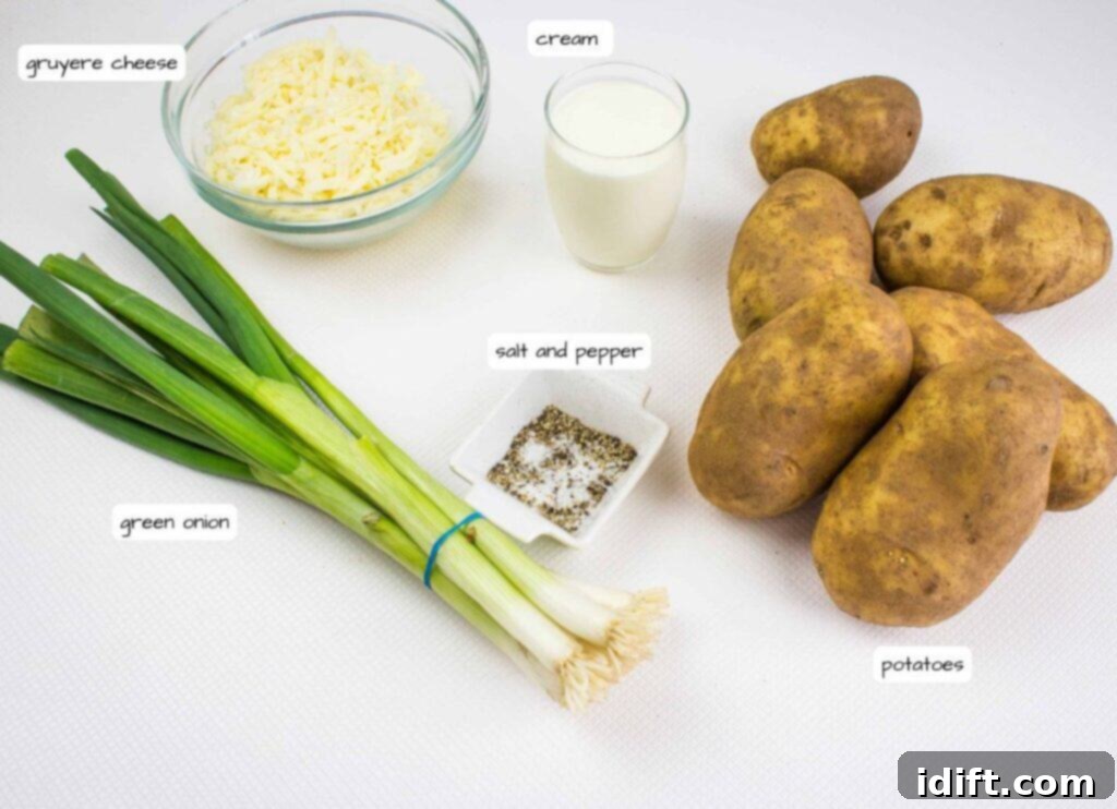 A bundle of green onions, a bowl of grated Gruyere cheese, a glass of cream, a dish of salt and pepper, and several russet potatoes on a white surface.