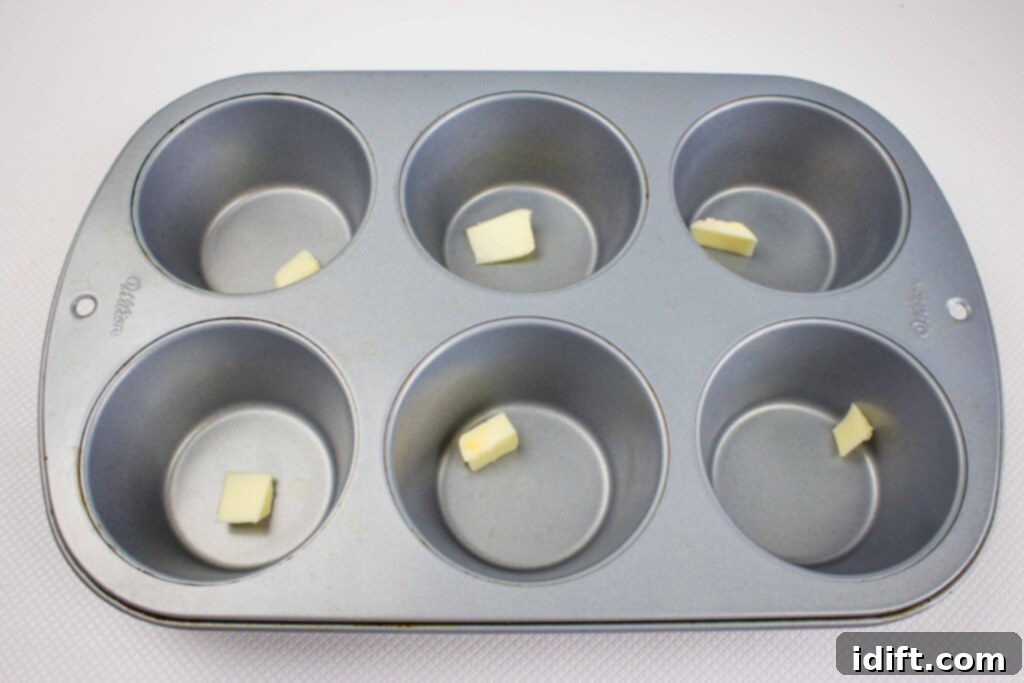 1/2 teaspoon of butter in each of the 6 muffin cups