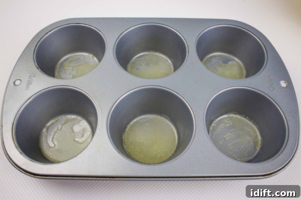 melted butter in the muffin cups