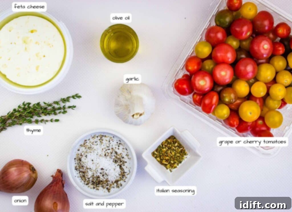 Assorted grape tomatoes, feta cheese, olive oil, garlic, thyme, onion, salt, pepper, and Italian seasoning arranged on a white surface.