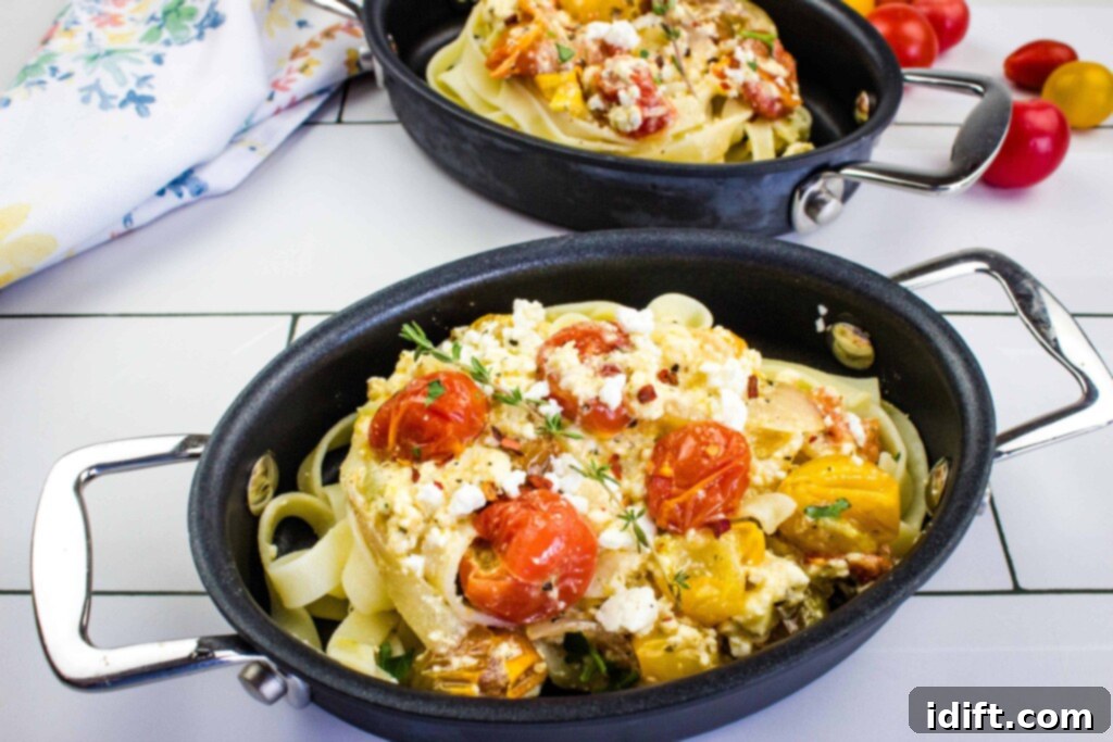 baked feta pasta in an oval black dish with a second in the background
