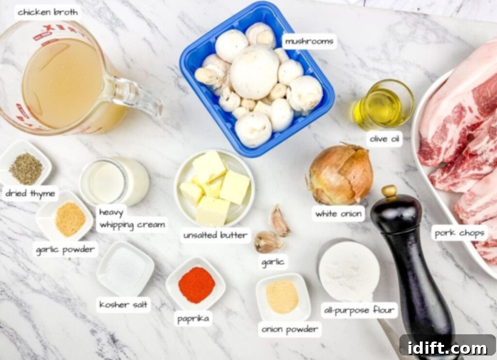 Ingredients labeled for Smothered Pork Chops with Onions & Mushrooms laid out on a marble surface, including chicken broth, mushrooms, pork chops, onion, spices, butter, cream, garlic, olive oil, and flour.