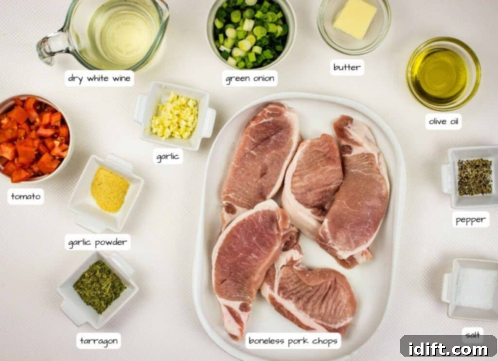 Overhead view of labeled ingredients for pork chops, including pork chops, green onion, butter, olive oil, pepper, salt, tarragon, garlic powder, garlic, tomato, and dry white wine, neatly arranged.