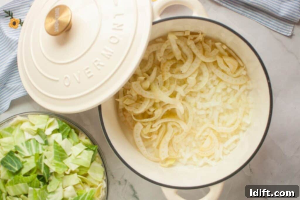 A large pot on a rustic wooden table, gently simmering cooked onions and chopped fennel, with a lid partially covering it, signaling the start of a delicious soup.