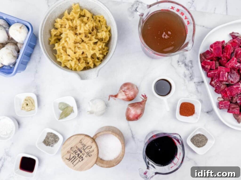 Hearty Beef Stroganoff Soup 5 An inviting assortment of fresh ingredients for Beef Stroganoff Soup, including delicate pasta, earthy mushrooms, rich beef, savory broth, robust wine, aromatic shallots, pungent garlic, and a selection of spices and seasonings, elegantly arranged on a pristine white marble surface, ready for culinary creation.