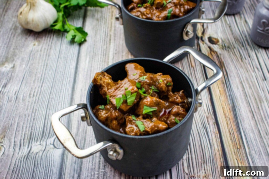 Hearty Hungarian Goulash 9 Two individual servings of authentic Hungarian Goulash in small, white, rustic pots, one in the foreground and another softly blurred in the background, ready to be enjoyed.