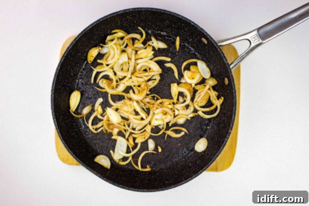 Hearty Hungarian Goulash 6 Sliced onions and chopped garlic sizzling in a skillet, turning translucent as they soften.