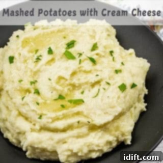 A black bowl filled with Grandma's Mashed Potatoes topped with chopped parsley.