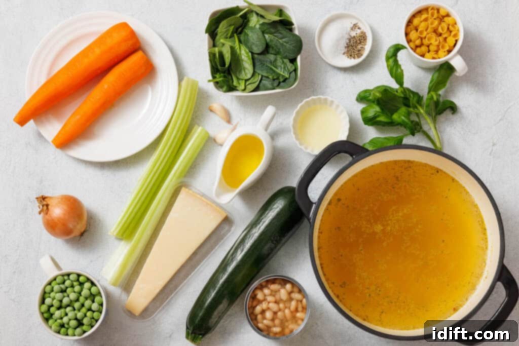 Vibrant Spring Minestrone 5 Ingredients for vegetable soup include carrots, spinach, pasta, spices, celery, onion, olive oil, zucchini, peas, cheese, beans, and broth in a pot on a white surface.
