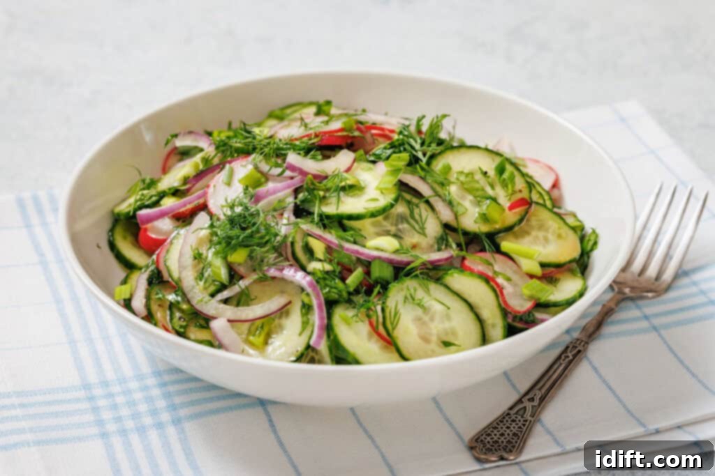 A bowl of Radish Salad with sliced red onions, radishes, and herbs on a cloth napkin with a fork beside it.