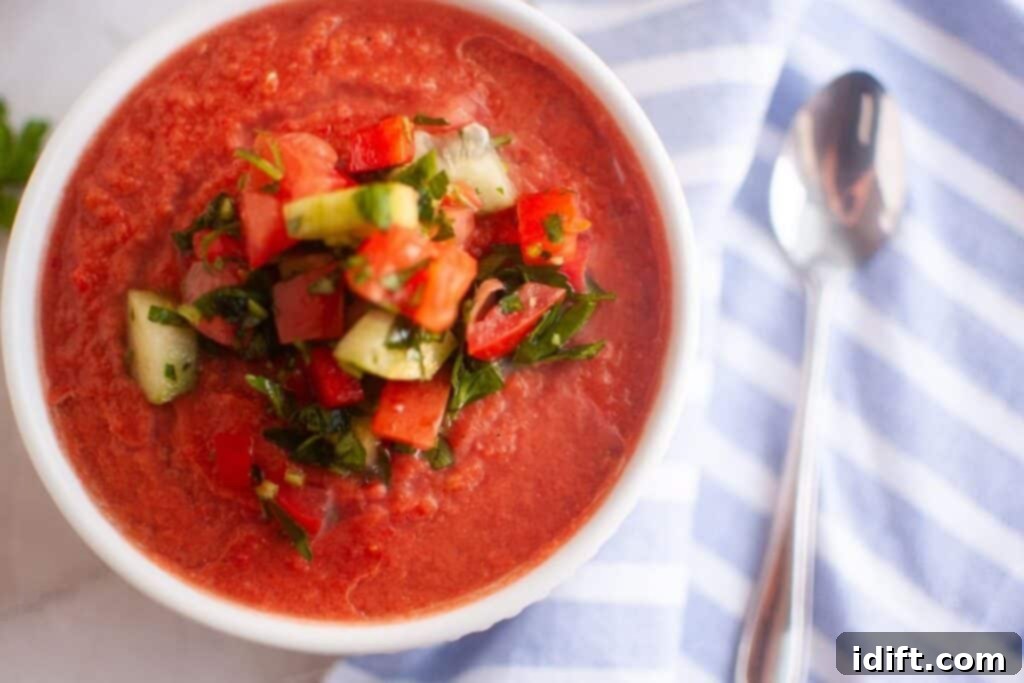 Cool and Refreshing Gazpacho 3 Delicious Classic Gazpacho served in elegant bowls with fresh garnishes.