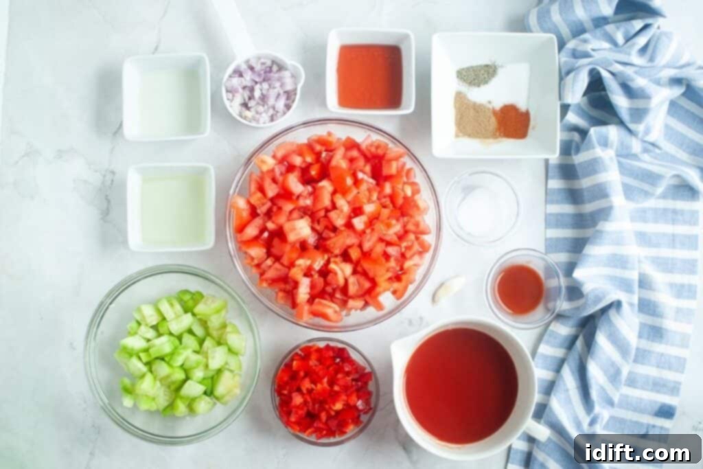 Cool and Refreshing Gazpacho 5 Ingredients for Classic Gazpacho laid out on a cutting board.