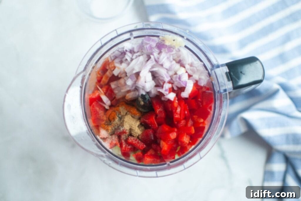 Cool and Refreshing Gazpacho 6 Adding chopped ingredients into a blender for Classic Gazpacho.