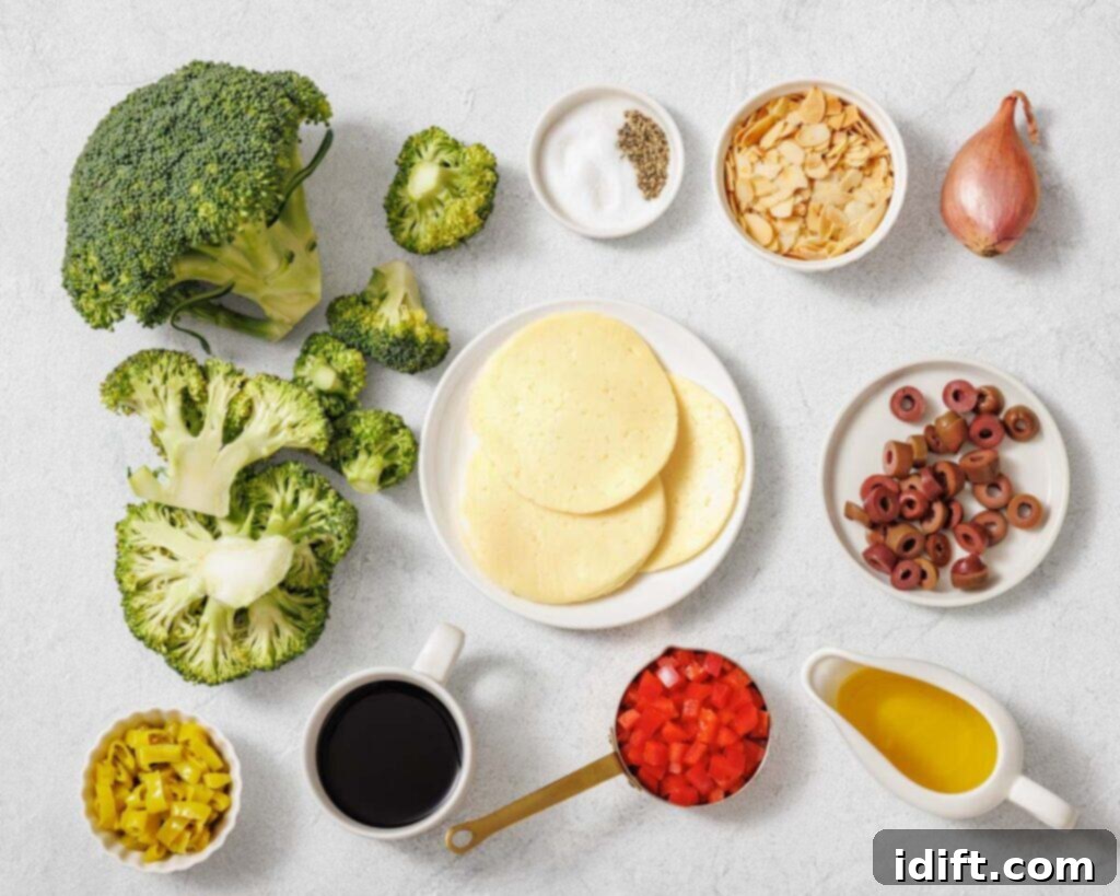 Ingredients arranged on a surface including broccoli, sliced cheese, chopped red peppers, black olives, shallot, almond slices, oil, vinegar, pepper, salt, and pepperoncini.
