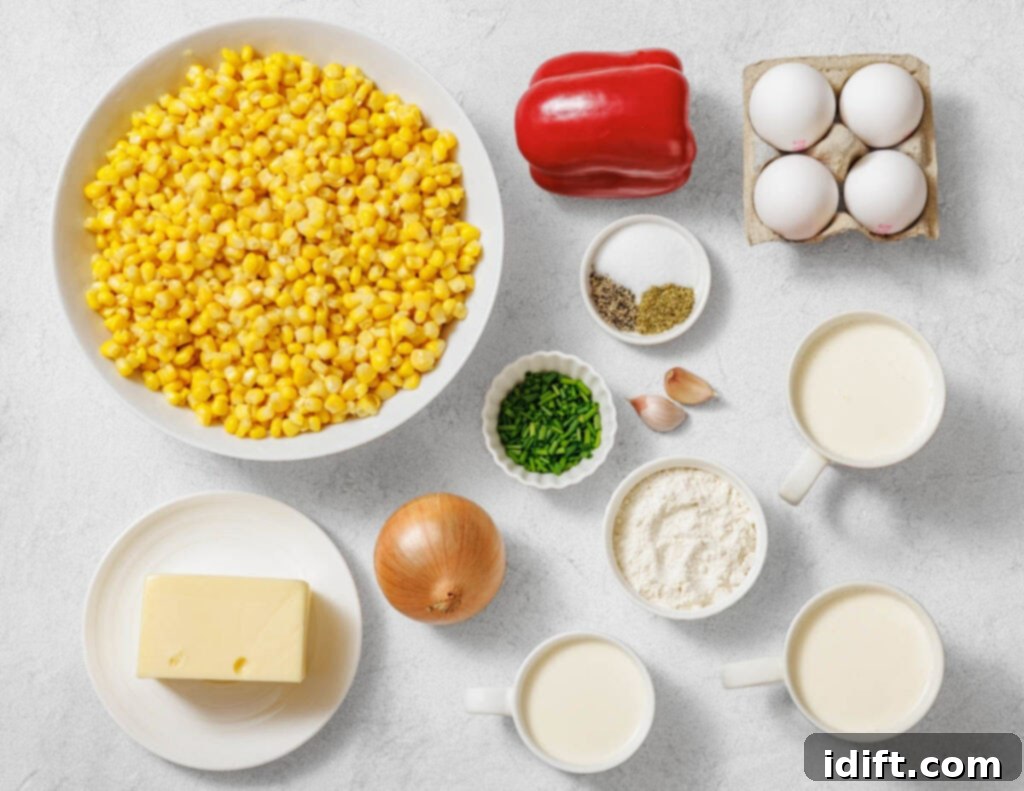 Creamy Golden Corn Bake 5 Assorted ingredients on a countertop including corn, red bell pepper, eggs, butter, onion, chives, seasonings, flour, garlic, milk, and cream.