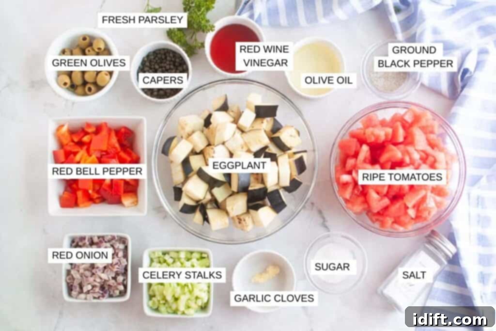 Ingredients for a recipe arranged in bowls on a white surface, including eggplant, tomatoes, peppers, onions, olives, capers, celery, garlic, parsley, and various seasonings.