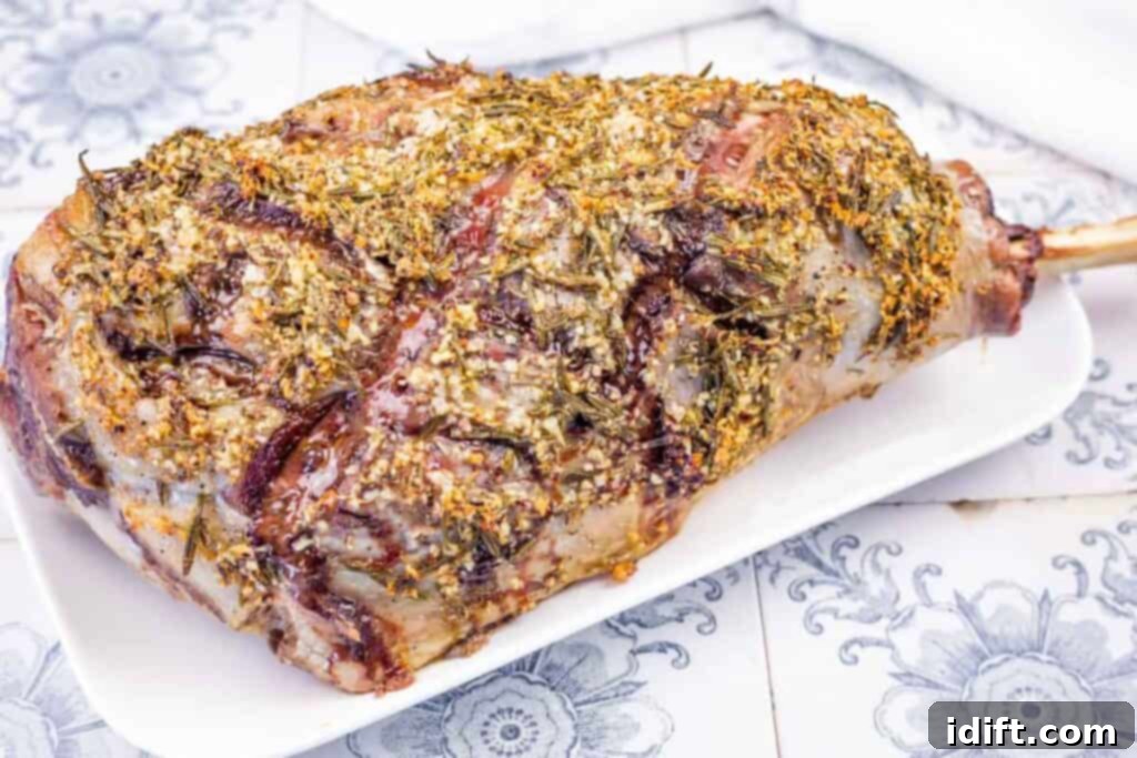Aromatic Slow-Roasted Lamb Leg 9 A beautifully roasted leg of lamb, perfectly seasoned with herbs, presented on a pristine white serving platter, ready for carving and enjoyment.