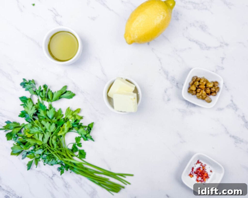 Overhead shot of the fresh ingredients for the bright lemon-caper sauce: zesty lemon, glistening olive oil, rich butter, briny capers, a sprinkle of red pepper flakes, and vibrant fresh parsley, all ready to be combined.
