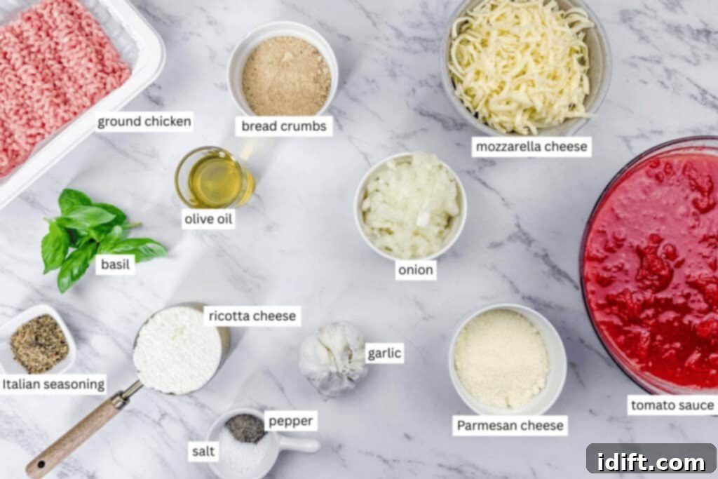 Ingredients for a recipe laid out on a marble surface, including ground chicken, cheese, tomato sauce, olive oil, breadcrumbs, onion, garlic, basil, and seasonings, each labeled.