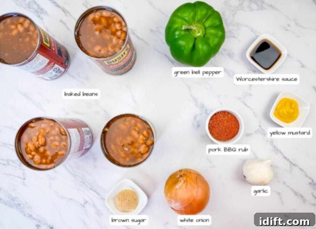 Cans of baked beans, green bell pepper, Worcestershire sauce, yellow mustard, pork BBQ rub, garlic, white onion, and brown sugar arranged on a marble surface, each labeled.
