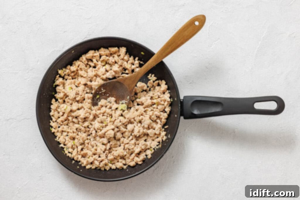 Lettuce wraps with meat and vegetables on a white table.