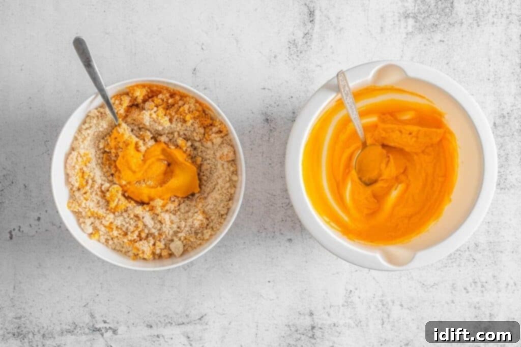 Two bowls on a white surface; the left bowl contains orange mixture with crumbled ingredients, the right bowl has a smooth orange mixture. Both have metal spoons.
