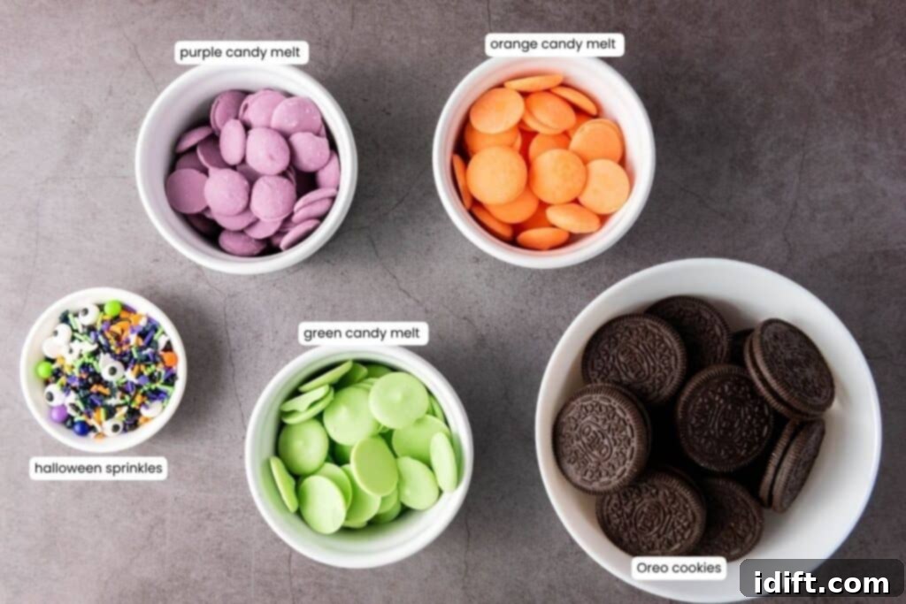 Five separate bowls containing the essential ingredients: vibrant purple candy melts, bright orange candy melts, classic green candy melts, an assortment of festive Halloween sprinkles, and a stack of delicious Oreo cookies, all neatly arranged and labeled on a sleek gray surface.