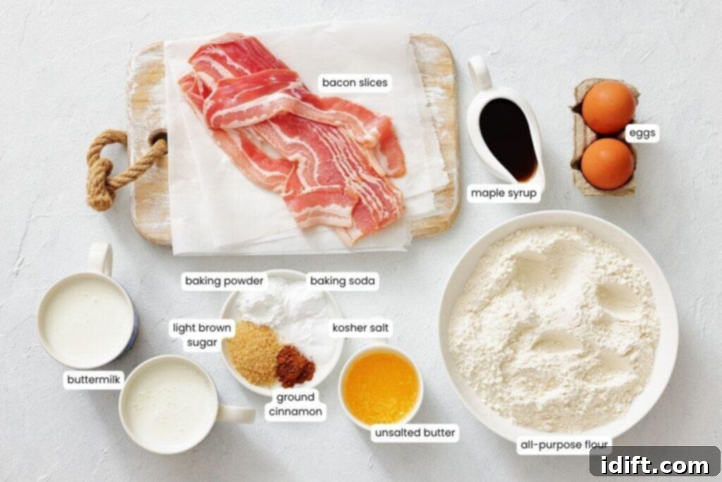 Top-down view of various labeled pancake ingredients, including bacon, eggs, maple syrup, flour, butter, buttermilk, sugars, cinnamon, baking powder, baking soda, and salt.