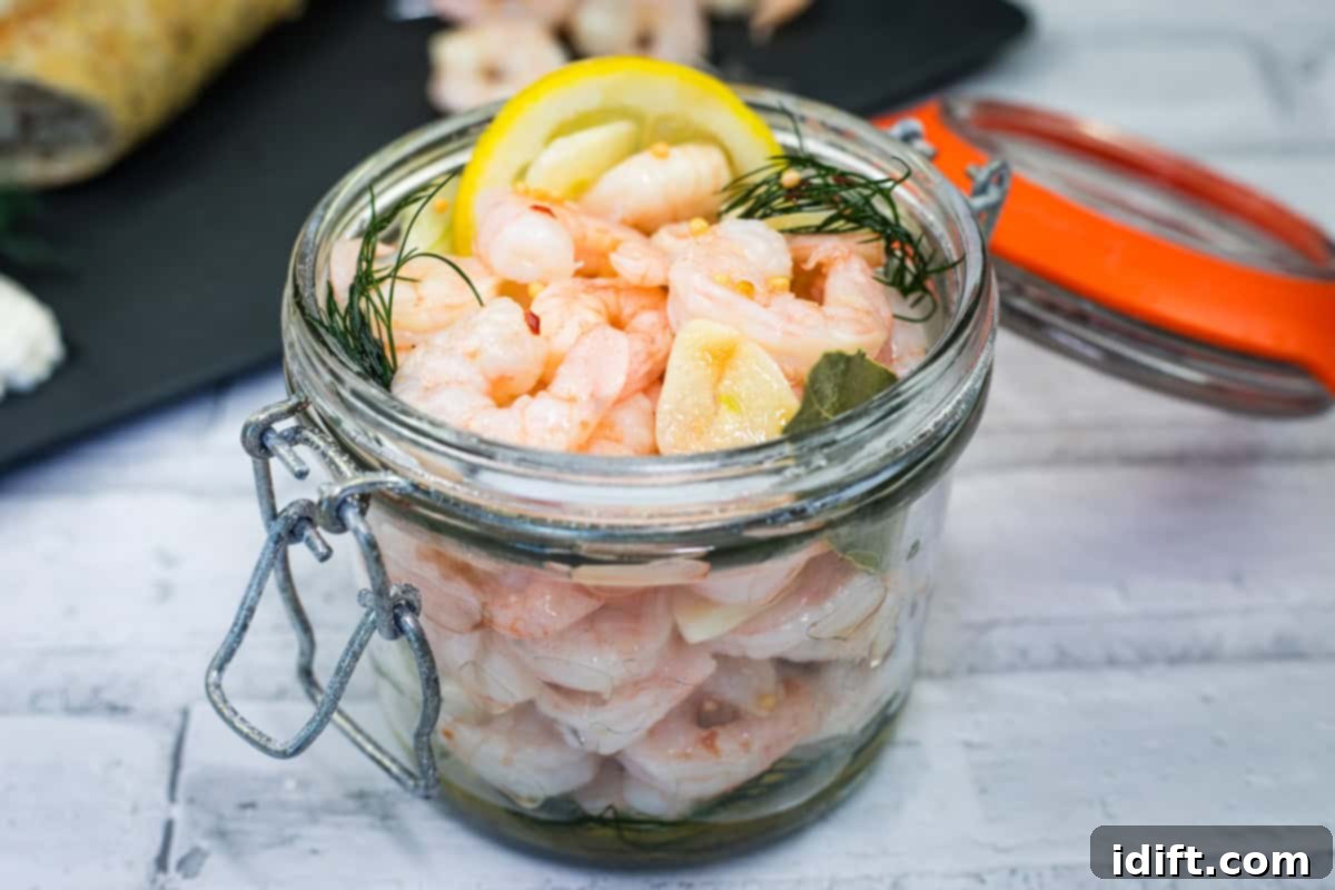 21 Halloween Bites So Good They'll Vanish Before Any Costume Compliments 14 Open jar filled with Southern Style Pickled Shrimp, dill, lemon slices, and herbs.