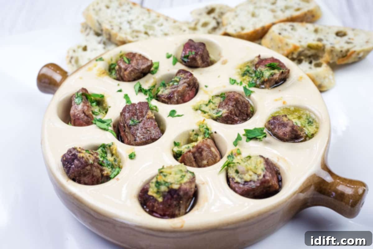 21 Halloween Bites So Good They'll Vanish Before Any Costume Compliments 10 Escargot-style Garlic Butter Steak Bites in a round dish.