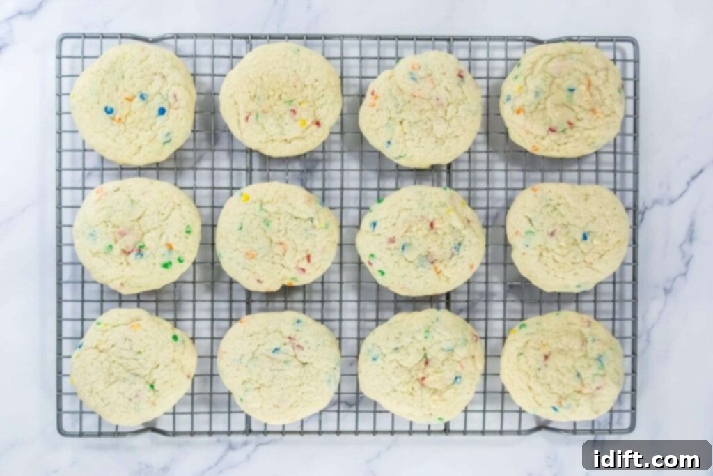 Baked confetti cake cookies cooling on a wire rack.