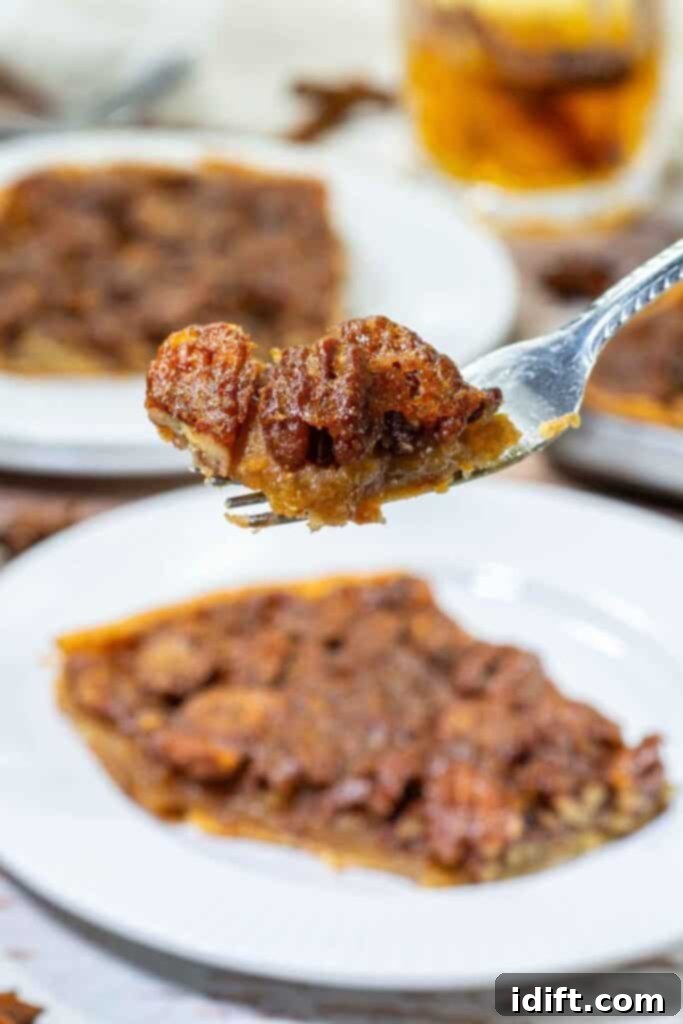 Fork holding a bite of pecan slab pie