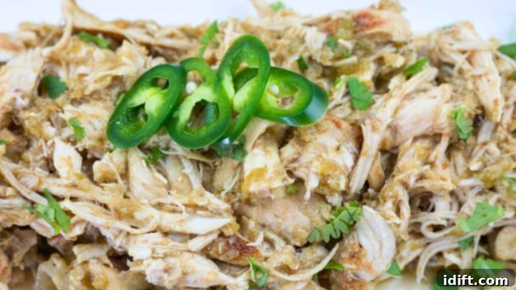 Shredded Hatch Chili Salsa Chicken garnished with jalapeños and cilantro