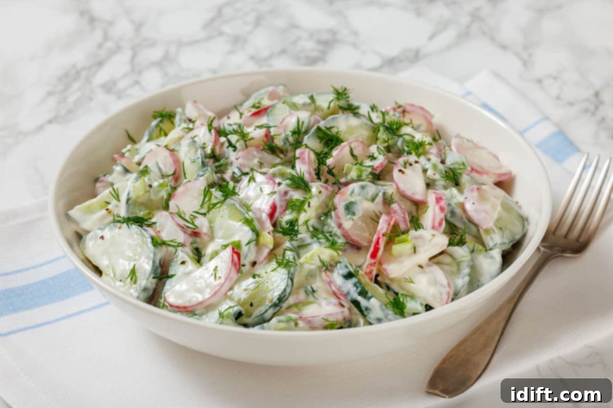 21 Spring-Inspired Dishes to Reinvent Your Week 3 A bowl of Creamy Radish Sala topped with fresh dill, was placed on a white and blue striped napkin with a fork beside it.