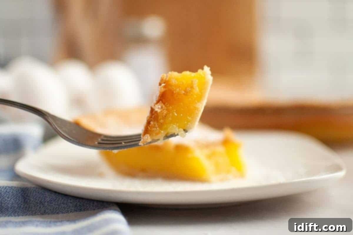 Timeless Kitchen Treasures: Rediscovering Vintage Recipes 7 A slice of Vinegar Pie held by a fork, revealing its unique texture and flavor.