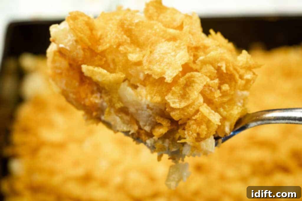 Timeless Kitchen Treasures: Rediscovering Vintage Recipes 10 Creamy Funeral Potatoes With Cream Cheese, topped with a golden, crispy cornflake crust.