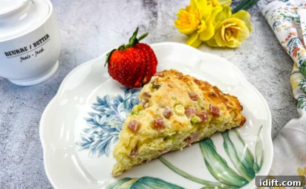A finished Ham & Cheese Scone on a plate with a berry